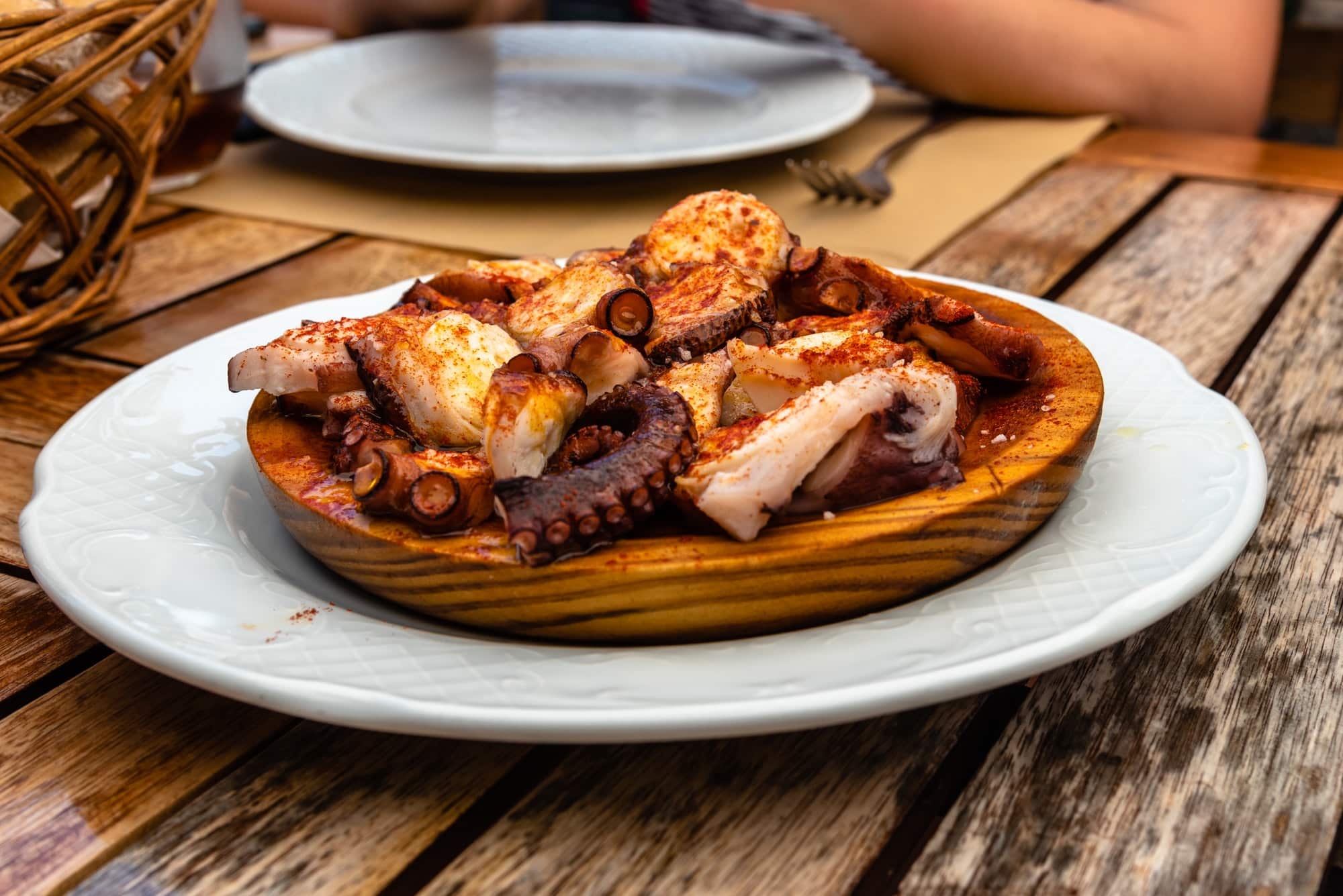 Galician style octopus with paprika, potatoes and olive oil in restaurant